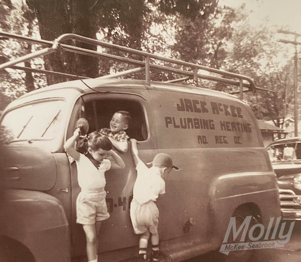 Molly’s dad, aunt and uncle playing on her grandfather’s McKee Plumbing & Heating truck
